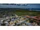 Scenic aerial view showcasing the neighborhood, nearby condos, and serene water views in this beautiful coastal community at 4704 Shale Pl, Tampa, FL 33615