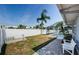 Spacious backyard featuring a screened pool area, lawn, and paved seating area at 4704 Shale Pl, Tampa, FL 33615