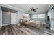 Stylishly furnished bedroom with hardwood floors, ample natural light, and a ceiling fan at 4704 Shale Pl, Tampa, FL 33615