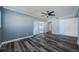 Serene bedroom with wood-look floors, ceiling fan, and closet space, creating a cozy retreat at 4704 Shale Pl, Tampa, FL 33615