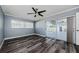 Bedroom with dark hardwood floors, a ceiling fan, and a glass sliding door to the pool at 4704 Shale Pl, Tampa, FL 33615