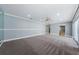 Open bonus room with carpet flooring, ceiling fan, and access to other areas of the home at 4704 Shale Pl, Tampa, FL 33615