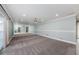 Spacious bonus room with carpet, a ceiling fan, and mirrored walls at 4704 Shale Pl, Tampa, FL 33615