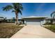Single story home with a two-car garage and lawn at 4704 Shale Pl, Tampa, FL 33615