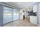 Bright kitchen with tile floors, white cabinets, granite countertops, and stainless steel appliances overlooking the pool at 4704 Shale Pl, Tampa, FL 33615
