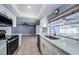Open concept kitchen features stainless steel appliances, ample counter space, and a view of the pool at 4704 Shale Pl, Tampa, FL 33615