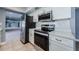 Well-equipped kitchen with stainless steel appliances, white cabinets, and sleek countertops at 4704 Shale Pl, Tampa, FL 33615