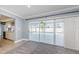Spacious living room with sliding glass doors open to the lanai and pool area, plus an open view to the kitchen at 4704 Shale Pl, Tampa, FL 33615