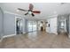 Open living space with tile flooring, sliding glass doors to the pool, and convenient access to the kitchen at 4704 Shale Pl, Tampa, FL 33615