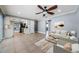 Bright open-plan living space with neutral tones, dining area, kitchen, and comfortable seating at 4704 Shale Pl, Tampa, FL 33615