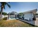 Outdoor view of screened pool with poolside seating and tropical landscaping at 4704 Shale Pl, Tampa, FL 33615