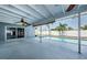 Large, screened-in pool area features a covered patio with a ceiling fan and view of the refreshing pool at 4704 Shale Pl, Tampa, FL 33615