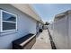 Paver side yard with storage and access to the backyard and pool area at 4704 Shale Pl, Tampa, FL 33615