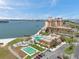 Scenic aerial view of beachfront condos with a pool, tennis court, parking and ocean views at 4900 Brittany S Dr # 805, St Petersburg, FL 33715
