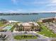 Aerial view showcases the building, waterfront, and nearby amenities, including a pool and beach at 4900 Brittany S Dr # 805, St Petersburg, FL 33715