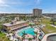Aerial view of a condo community featuring a pool, tennis courts, and a surrounding picturesque setting at 4900 Brittany S Dr # 805, St Petersburg, FL 33715