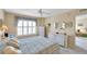 Bright bedroom featuring white furniture, a large window with shutters, and soft, neutral walls at 4900 Brittany S Dr # 805, St Petersburg, FL 33715