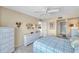 Comfortable bedroom showcasing white furniture, neutral colors, and a view into the bathroom at 4900 Brittany S Dr # 805, St Petersburg, FL 33715