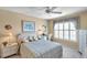 Cozy bedroom with blue and yellow bedding, a large window, and neutral colored walls at 4900 Brittany S Dr # 805, St Petersburg, FL 33715