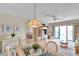 Inviting dining room with wicker furniture, plants, and bright natural light and a view of the adjacent living room at 4900 Brittany S Dr # 805, St Petersburg, FL 33715