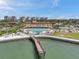 A pier leads to a swimming pool at a tropical resort destination at 4900 Brittany S Dr # 805, St Petersburg, FL 33715