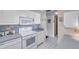 Functional kitchen with white appliances, tiled backsplash, and ample cabinet space at 4900 Brittany S Dr # 805, St Petersburg, FL 33715