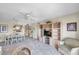 Open-concept living area with wicker furniture, television, dining room and pass-through to the kitchen at 4900 Brittany S Dr # 805, St Petersburg, FL 33715