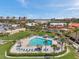 Community pool featuring palm trees and lounge chairs, surrounded by residential buildings at 4900 Brittany S Dr # 805, St Petersburg, FL 33715