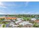 Expansive view from condo balcony overlooking a lake, residences with red tile roofs, and lush landscaping at 4900 Brittany S Dr # 805, St Petersburg, FL 33715