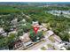 Aerial view of a home in a wooded neighborhood with surrounding houses and mature trees at 5021 Roanoke Dr, Holiday, FL 34690