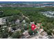 Aerial view of a house in a neighborhood with a red pin indicating its location at 5021 Roanoke Dr, Holiday, FL 34690