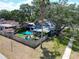 Aerial view of a charming home with a fenced backyard, patio area, and mature trees at 5021 Roanoke Dr, Holiday, FL 34690