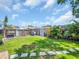 Fenced backyard with a lush lawn and ample space for outdoor activities and storage sheds at 5021 Roanoke Dr, Holiday, FL 34690