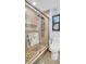 Modern bathroom with glass shower, pebble floor, and custom tile details at 5021 Roanoke Dr, Holiday, FL 34690