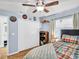 Charming bedroom featuring a ceiling fan, wood floors, and ensuite bathroom at 5021 Roanoke Dr, Holiday, FL 34690
