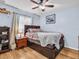 Bedroom with a ceiling fan, wood floors, and window at 5021 Roanoke Dr, Holiday, FL 34690