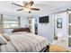 Charming bedroom with a sliding door to the bathroom and walk-in closet with ceiling fan at 5021 Roanoke Dr, Holiday, FL 34690