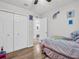 ' bedroom with wood floors and ensuite bathroom at 5021 Roanoke Dr, Holiday, FL 34690