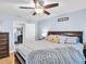 Spacious bedroom with a large bed, ceiling fan, and connection to the living room through the doorway at 5021 Roanoke Dr, Holiday, FL 34690