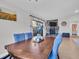 Open dining room with stone fireplace, sliding door to back patio, and hardwood flooring at 5021 Roanoke Dr, Holiday, FL 34690