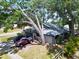 Charming home with mature trees, providing shade and curb appeal to the property at 5021 Roanoke Dr, Holiday, FL 34690