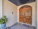 Close-up of the front entrance, highlighting the ornate wooden doors and tiled porch at 5021 Roanoke Dr, Holiday, FL 34690