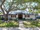 Charming single-story home with mature trees, a well-manicured lawn and inviting entry at 5021 Roanoke Dr, Holiday, FL 34690