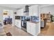 Modern kitchen with stainless steel appliances, sleek cabinets, and granite counters open to dining and living areas at 5021 Roanoke Dr, Holiday, FL 34690
