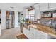 Bright, updated kitchen features a stainless steel refrigerator, farmhouse sink, and granite countertops at 5021 Roanoke Dr, Holiday, FL 34690