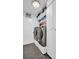 Laundry room with washer and dryer, storage cabinets and gray floors at 5021 Roanoke Dr, Holiday, FL 34690