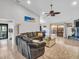 Bright living room with a comfy sofa, a stone fireplace, and access to the backyard at 5021 Roanoke Dr, Holiday, FL 34690