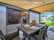 Covered outdoor patio with a dining table and seating, perfect for entertaining guests at 5021 Roanoke Dr, Holiday, FL 34690