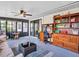 Comfortable sunroom with an entertainment center, ceiling fan, and sliding glass doors leading outside at 5021 Roanoke Dr, Holiday, FL 34690