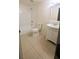 Clean bathroom with a shower and tub combination, white vanity, and tiled floors at 5122 Dove Dr, New Port Richey, FL 34652